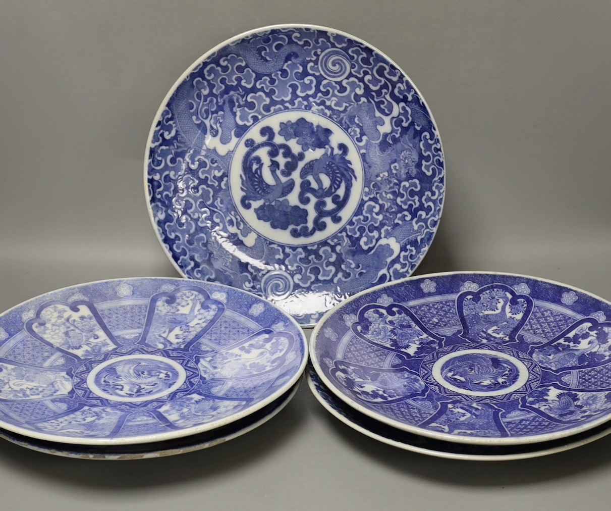 Five early 20th century Japanese blue and white dishes, largest 30.5cm diameter